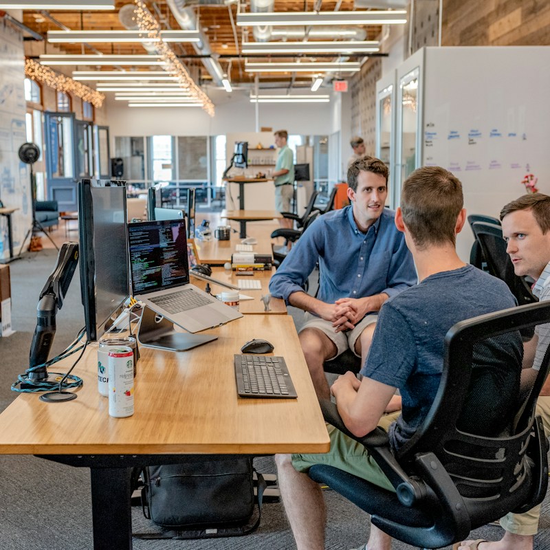 Team discussing ideas around a workspace
